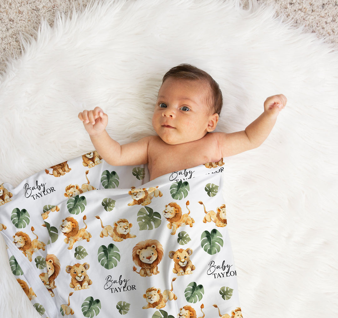 Newborn baby wrapped in personalised swaddle blanket and matching custom beanie for newborn photo shoot