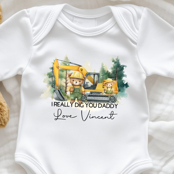 Personalised I Really Dig You Daddy baby onesie featuring a cute digger truck design and custom name option, laid flat on a white background.