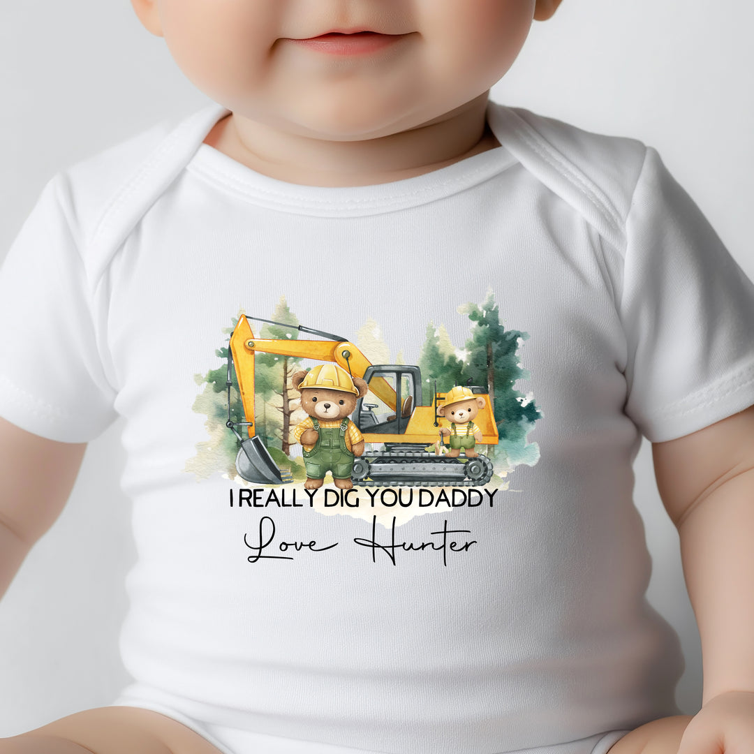 Close-up of personalised I Really Dig You Daddy onesie with digger truck illustration, custom name print, and snap crotch closures