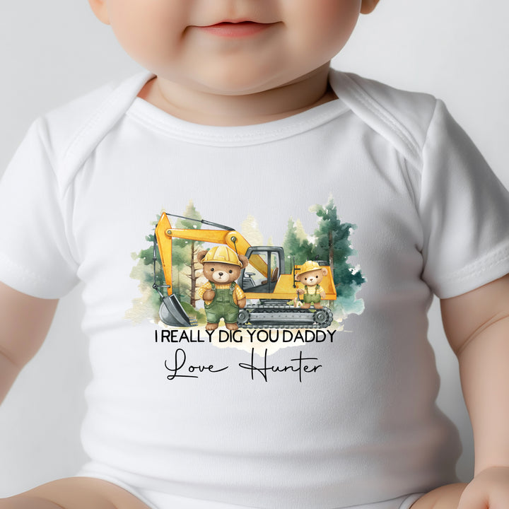 Close-up of personalised I Really Dig You Daddy onesie with digger truck illustration, custom name print, and snap crotch closures
