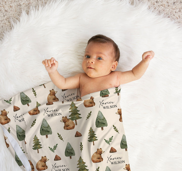 Personalised baby swaddle wrap used as a blanket in a bassinet or cot