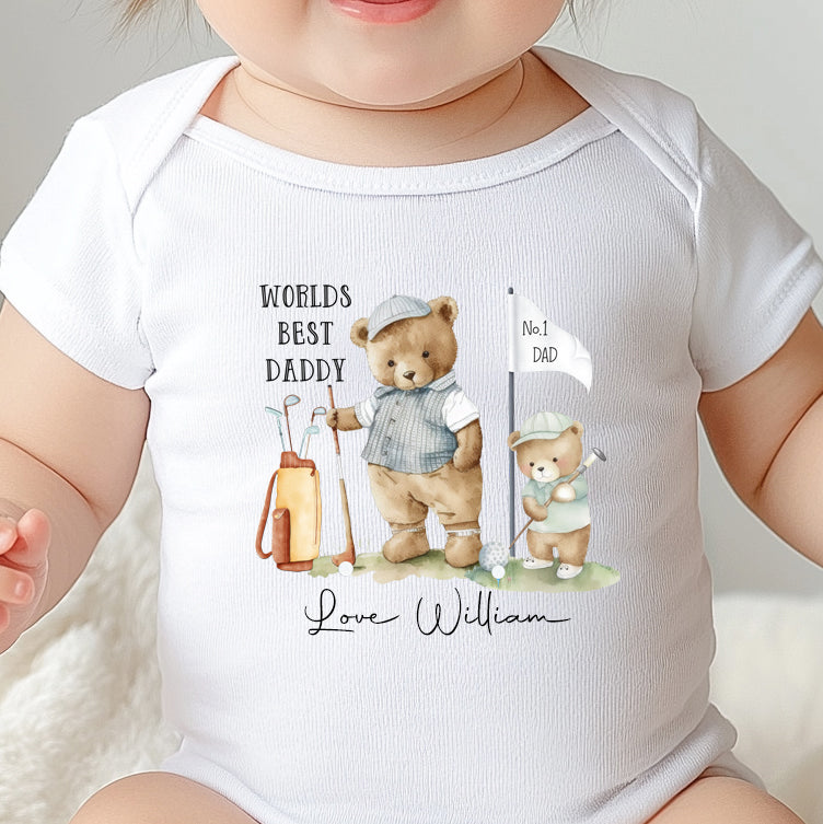 Baby wearing a soft cotton ‘World’s Best Daddy’ onesie with cute golfing design for first Father’s Day gift