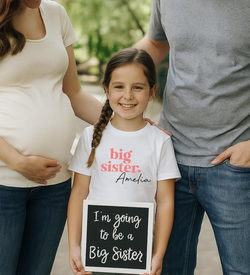 White Big Sister T-Shirt on hanger – custom kids' clothing for pregnancy announcements and big sister gifts