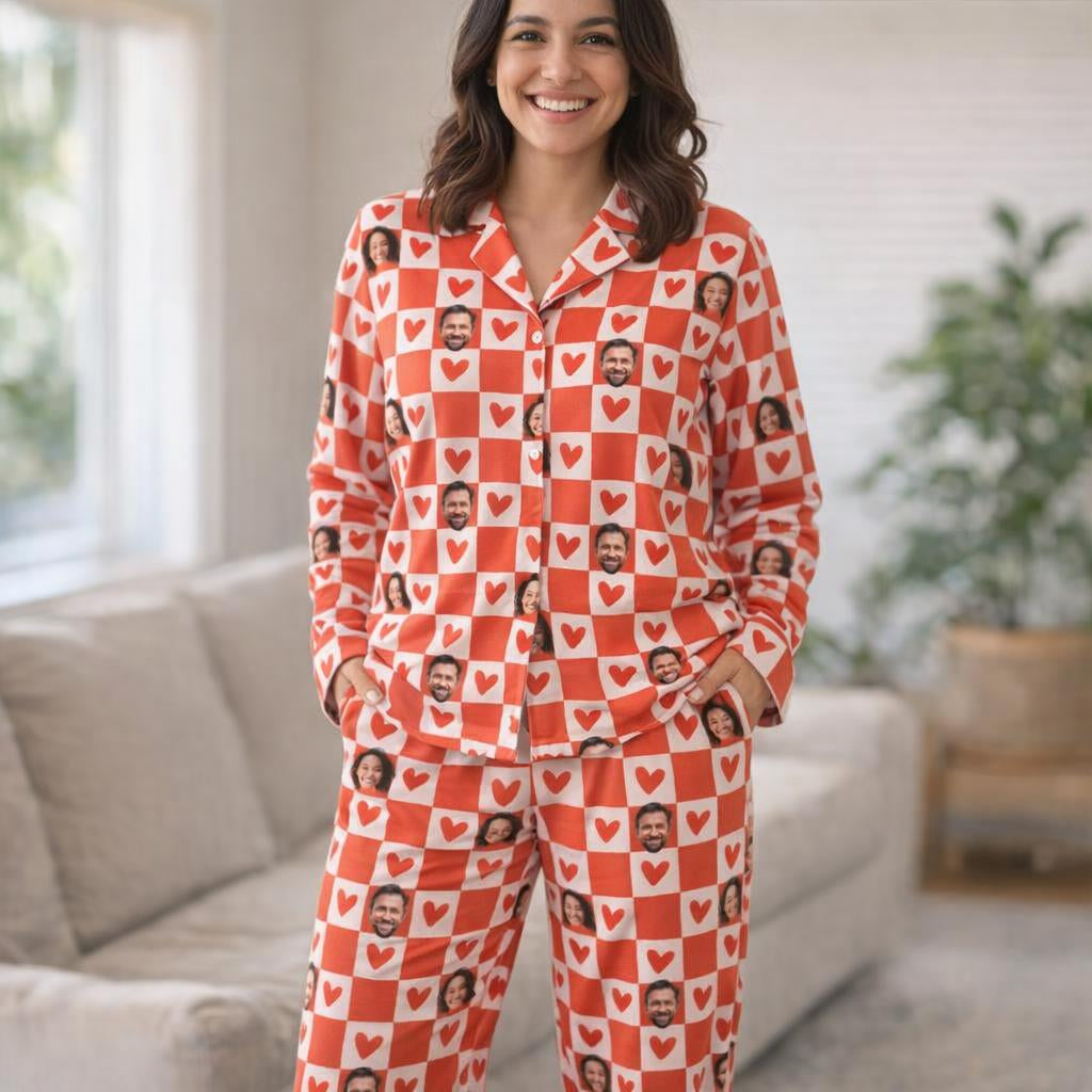 Woman wearing a red and white pajama set with heart patterns in a living room.