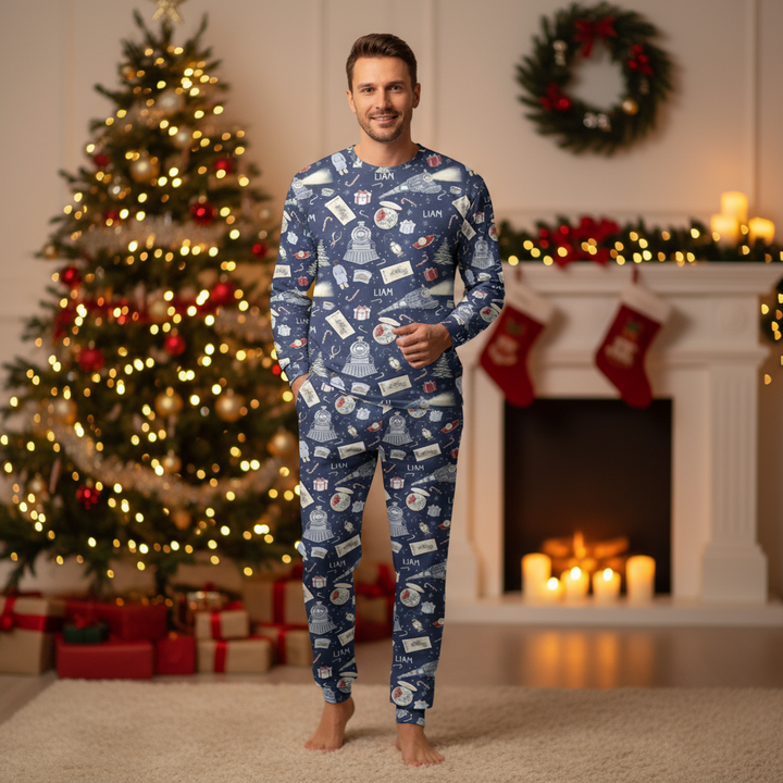 Man wearing blue Christmas pajamas in a festive room with a tree and fireplace.