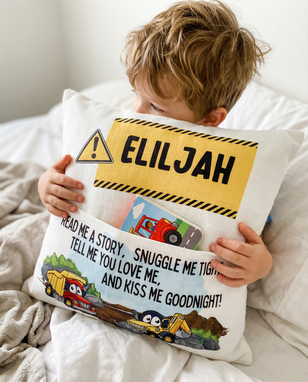 Personalised construction pocket book cushion with truck and excavator designs and child's name on front