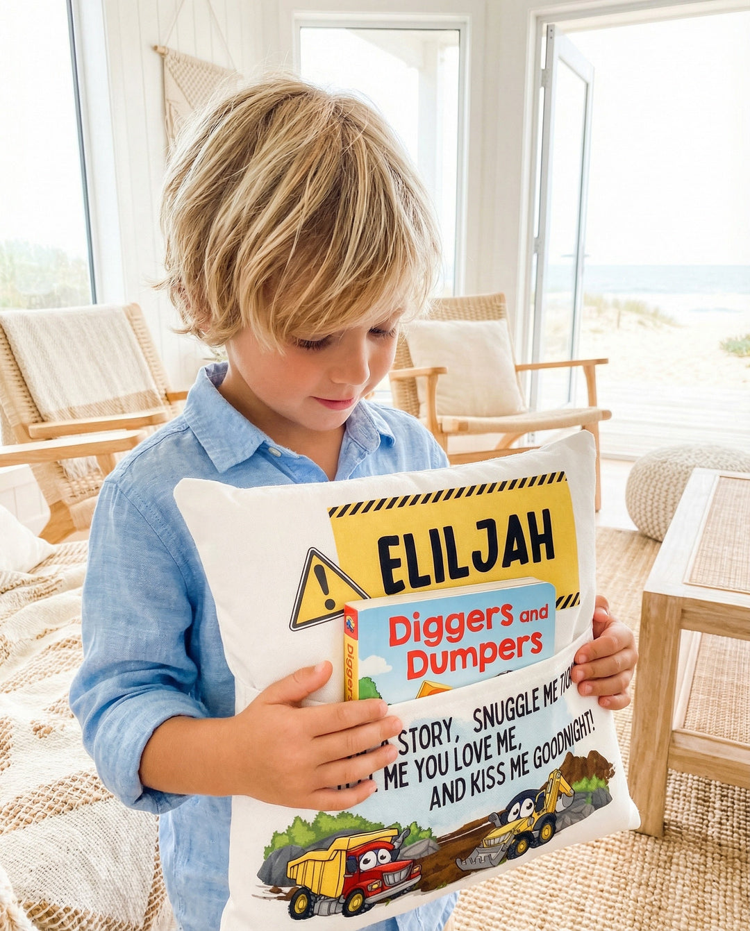 Personalised construction pocket book cushion with trucks and excavators for boys, featuring a built-in book pocket and custom name.