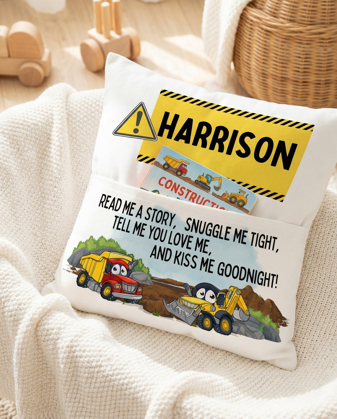 Personalised construction pocket book cushion with trucks and child's name, featuring a built-in book pocket for boys.