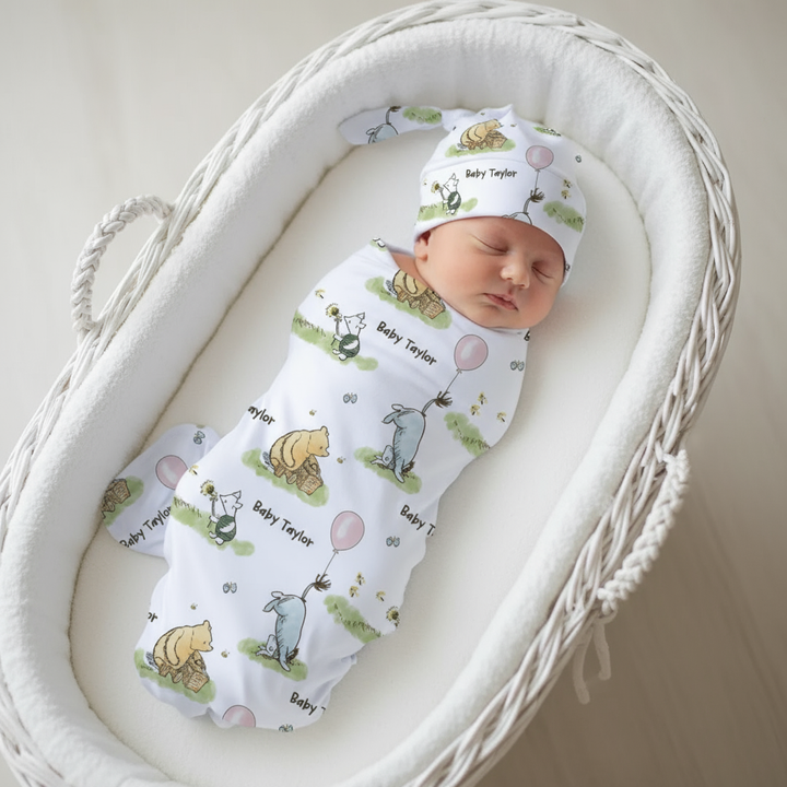 Newborn baby wrapped in a patterned swaddle and hat in a white crib.